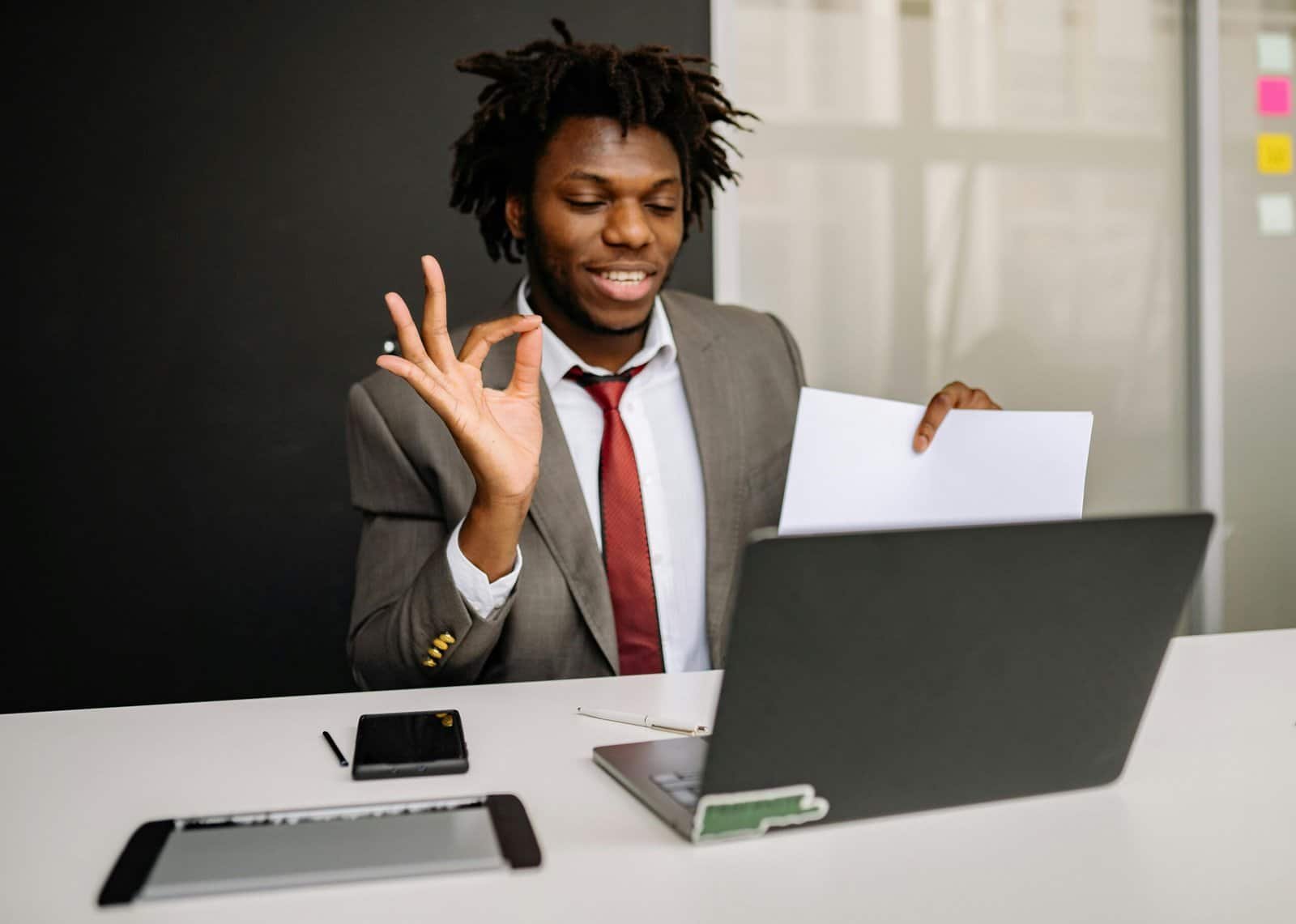 Business professional smiling while reviewing results on laptop, representing successful AI automation and customer engagement with AI Meta Verified Agents