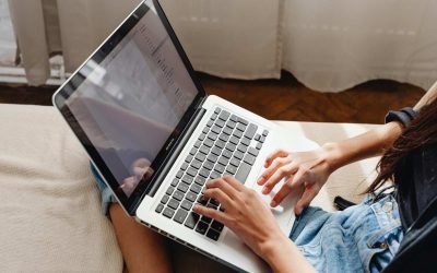 Person using a laptop while managing business automation tasks with AI chatbots